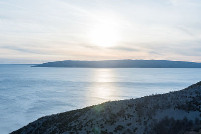 Scenic view of sea against cloudy sky