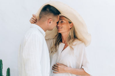Young romantic couple in love kissing. pregnant woman with her husband.