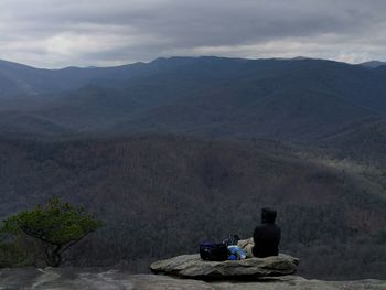 Scenic view of mountains against cloudy sky