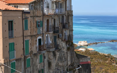 Buildings by sea against sky in city