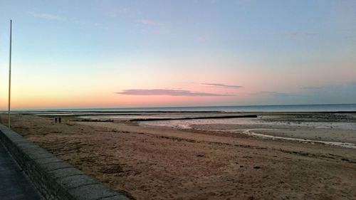 Scenic view of beach against sky during sunset