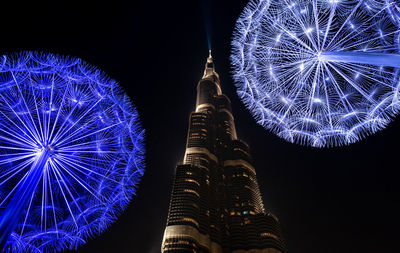 Low angle view of illuminated ferris wheel at night