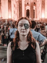 Portrait of young woman wearing eye patch