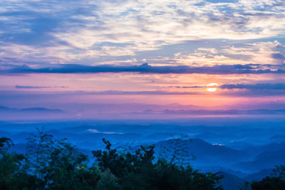 Scenic view of mountains against cloudy sky