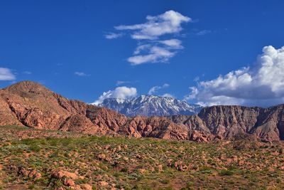 Scenic view of mountains against blue sky