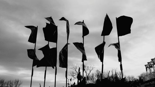 Low angle view of flags against sky