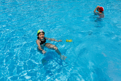 High angle view of woman swimming in pool
