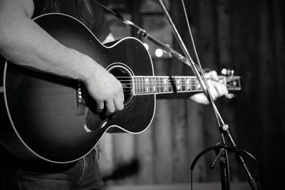 Midsection of woman playing guitar