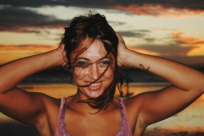 Portrait of beautiful woman against sky during sunset