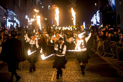 Group of people on street in city at night