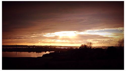 Scenic view of lake at sunset