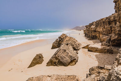 Pithy rocky coast at praia da varandinha on the popular island of boa vista, cape verde