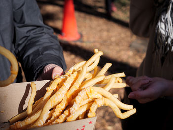 Cropped image of hand holding burger