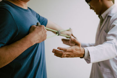 Midsection of couple holding hands