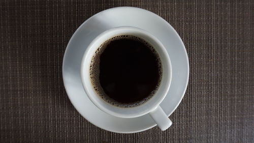 High angle view of black coffee on table