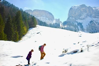 Panoramic view of people on snowcapped mountains
