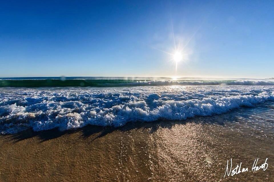 clear sky, water, scenics, winter, snow, cold temperature, tranquil scene, beauty in nature, blue, tranquility, nature, sea, copy space, sunlight, sun, frozen, idyllic, season, sky, waterfront