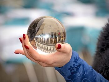 Close-up of hand holding crystal ball