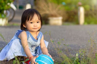 Portrait of cute baby girl holding ball