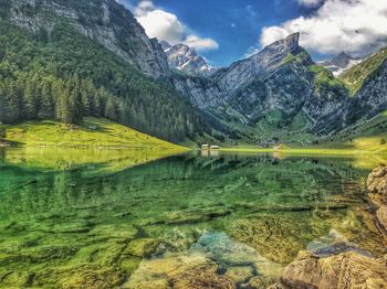 Scenic view of lake and mountains against sky