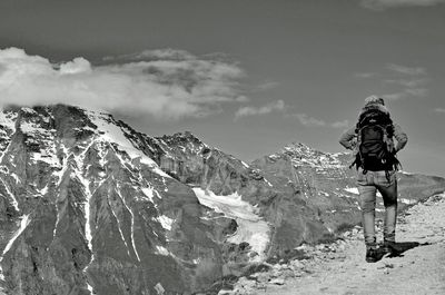 Rear view of person on snowcapped mountains against sky