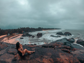 Girl sitting on the beach in karnataka