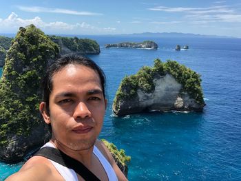 Portrait of young man looking at sea