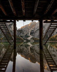 Reflection of bridge in lake against sky