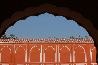 Low angle view of illuminated building against clear blue sky