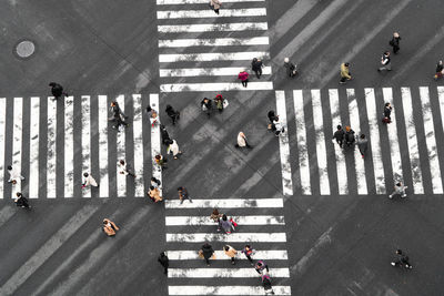 High angle view of people crossing road