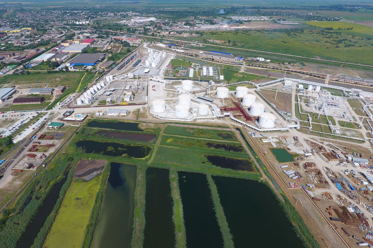 HIGH ANGLE VIEW OF CITY BY ROAD IN FIELD