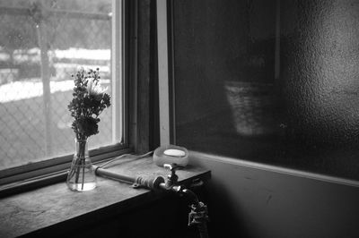 Close-up of vase against window at home