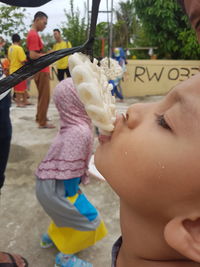 Close-up of boy eating food during game at playground