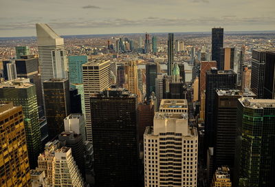 Aerial view of modern buildings in city against sky