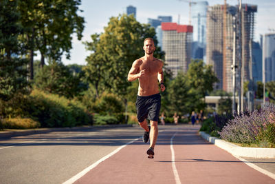 Full length of man running on road