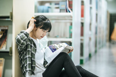 Woman sitting on book