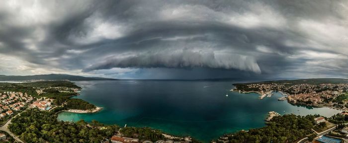 Scenic view of sea against storm clouds