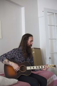 Young man playing an acoustic guitar