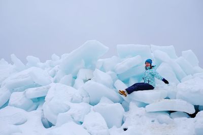 Person in snow against sky during winter