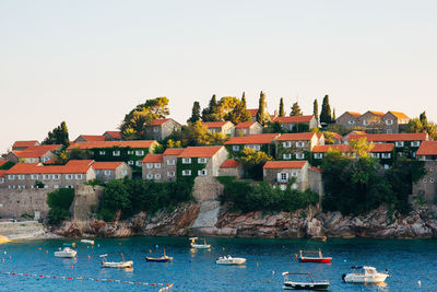 Scenic view of sea and buildings against clear sky