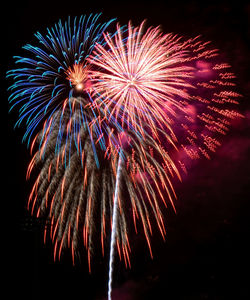 Low angle view of firework display at night