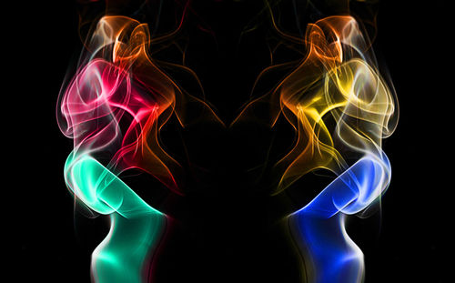 Close-up of colorful light painting against black background