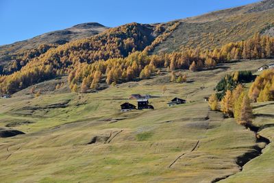 Scenic view of land and mountains against sky