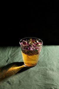Close-up of drink on table against black background