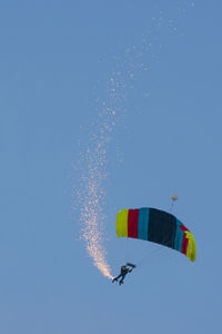 Low angle view of kite flying against clear blue sky