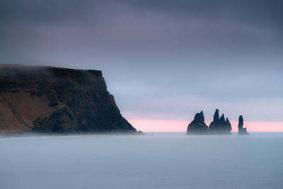 Scenic reynisdrangar cliff during sunrise on a stormy cloudy morning in iceland