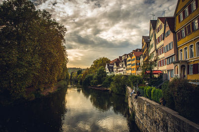 Canal amidst buildings against sky