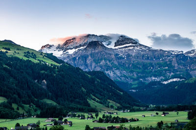 Scenic view of snowcapped mountains against sky