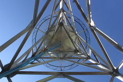 Low angle view of solar powered water tank against clear blue sky