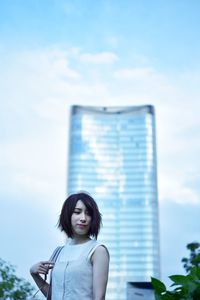 Portrait of woman standing against sky